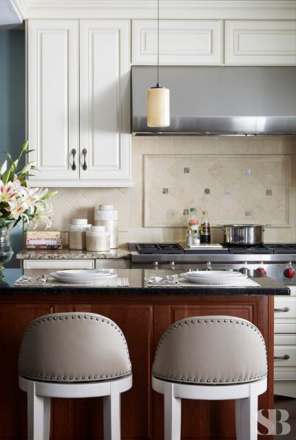 two upholstered barstools against a kitchen island