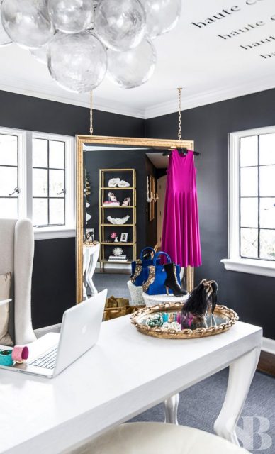 white desk with hanging mirror in corner