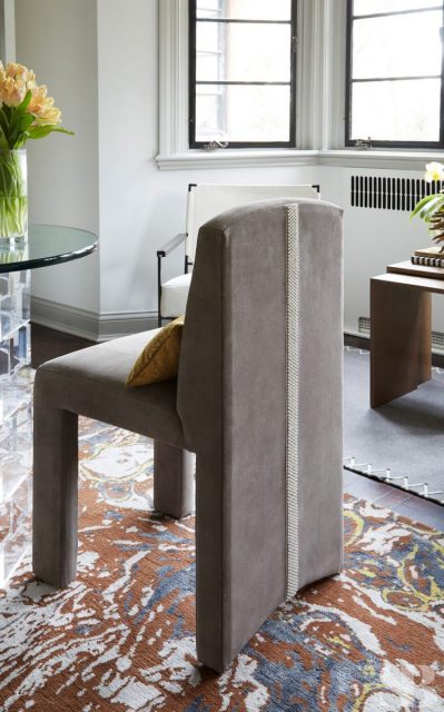 gray suede armchair with beaded back detail