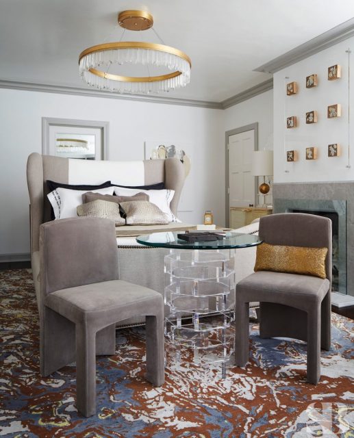 upholstered king floating bed and two gray chairs