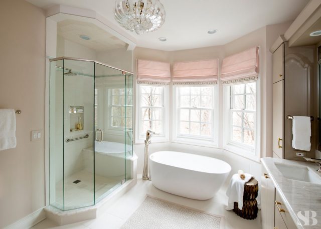 glass steam shower and stand alone white bathtub