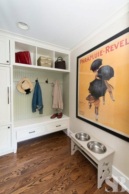 mudroom with coat hooks and two dog bowls