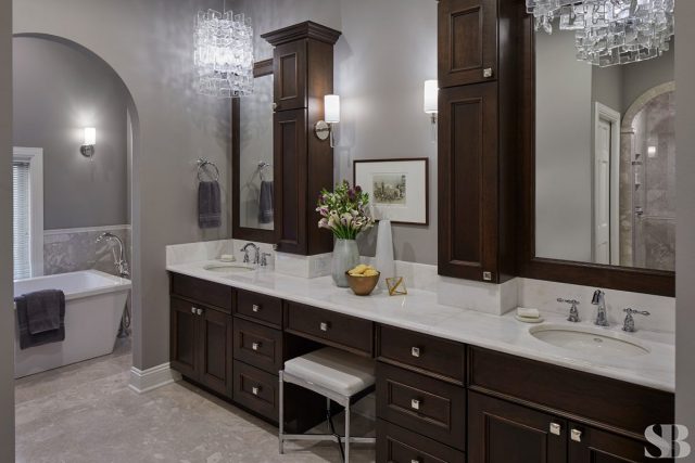 master bathroom remodel with dark cherry wood, white counter tops, and a vanity
