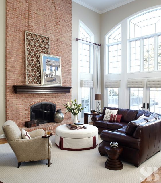 famil room with leather sectional and brick fireplace