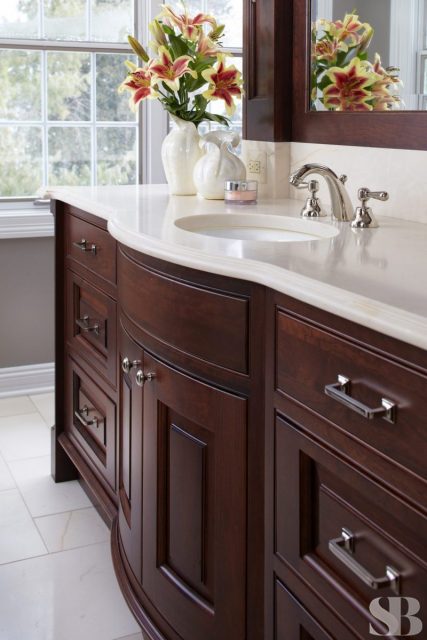 dark wooden bathroom cabinets and sink