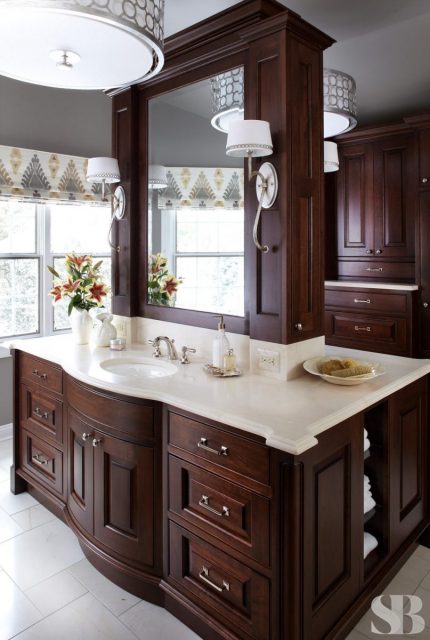 master bathroom with dark wood cabinets and double sided center island