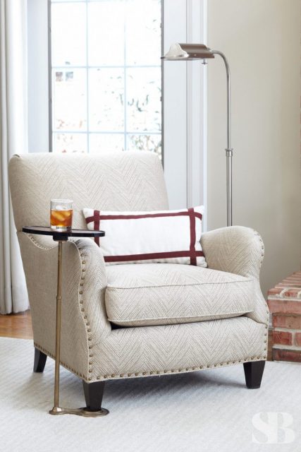 white upholstered arm chair with reading lamp