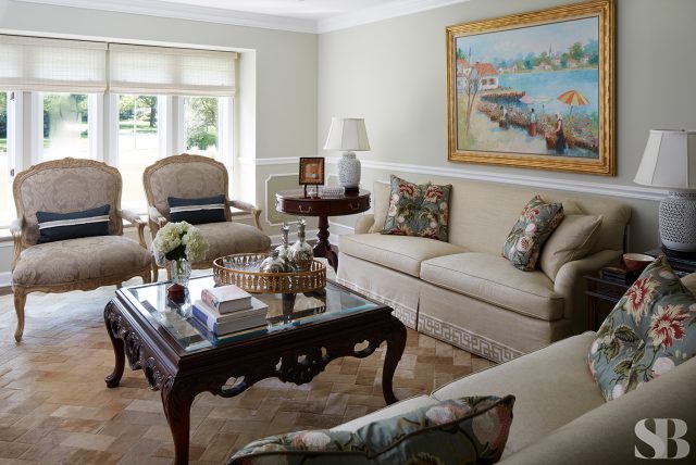 living room with two cream sofa and two chairs and a dark cherry wood coffee table