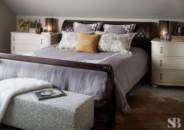wooden sleigh bed with grey bedding