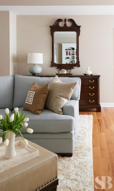 light blue sectional arm with beige pillows