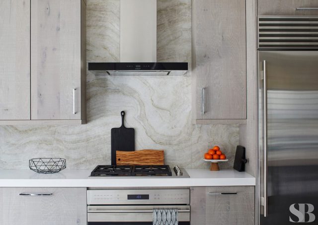 stove and light swirled marble backsplash