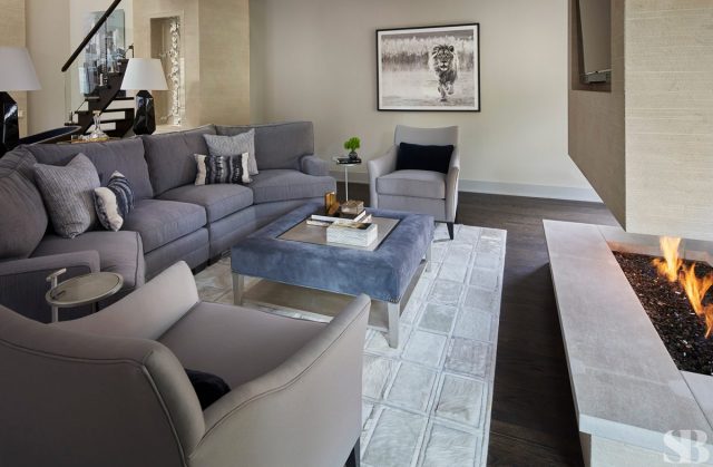 living room with light gray sofa and suede ottoman