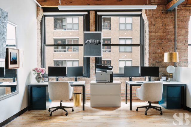 office space with two desks against window