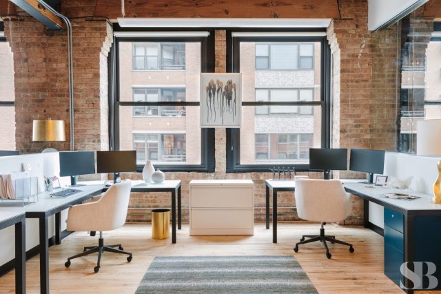 Office space with two desks and rug